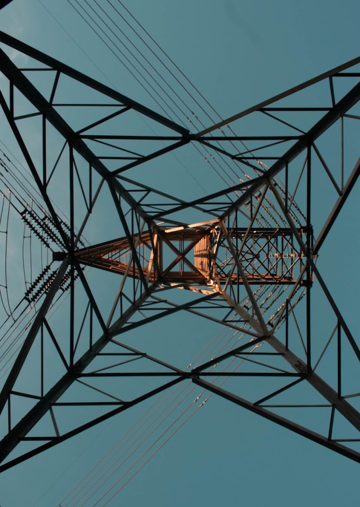 an overhead view of a power line with a blue sky in the background